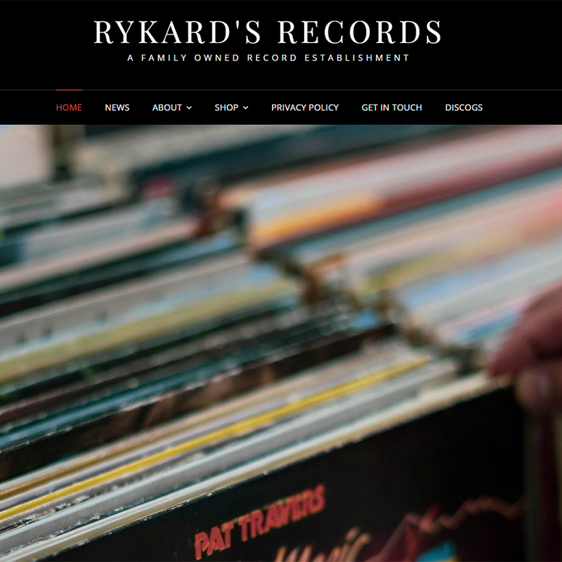 Screenshot of WordPress site with the heading Rykards Records, featuring a picture of a hand browsing through a crate of records.